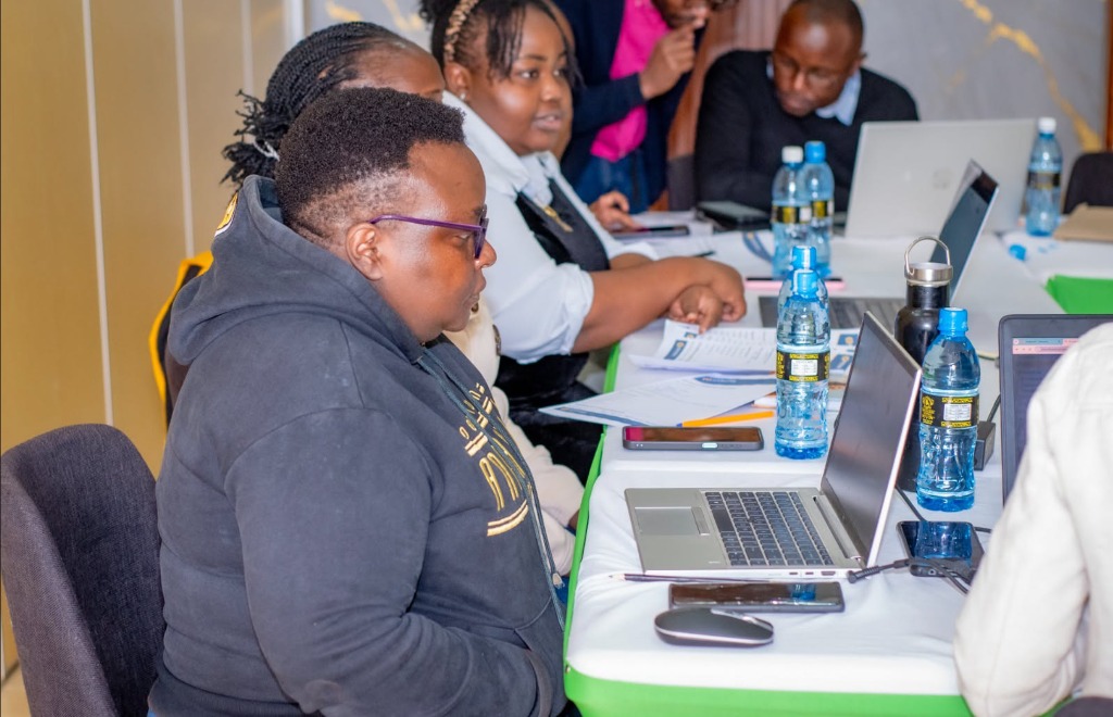 Attendees collaborating around laptops at the Ndovesha AI Physical Masterclass