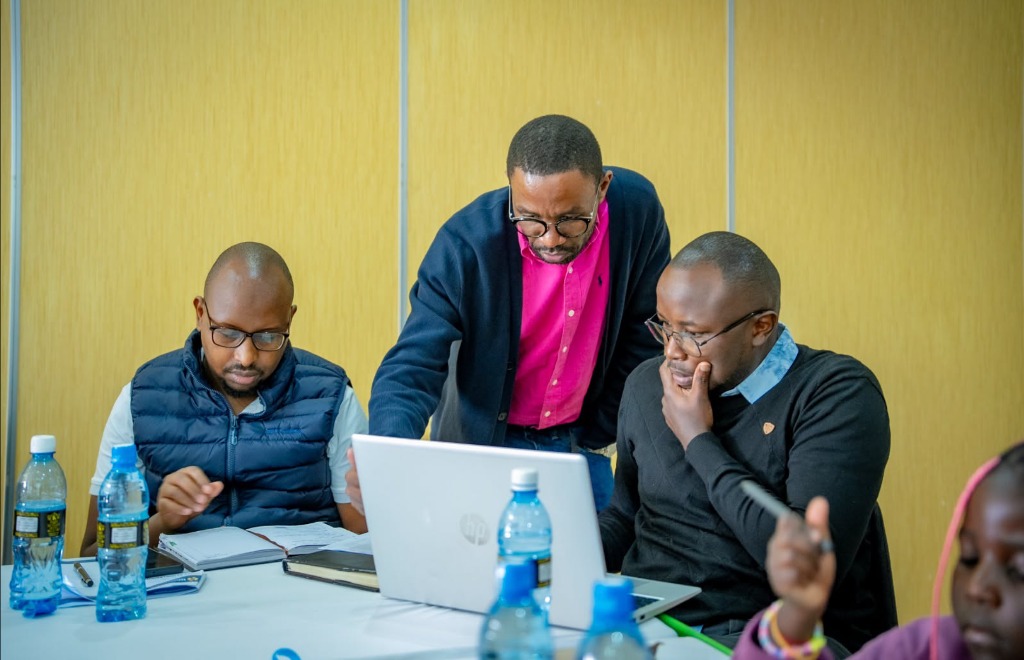 Participants reviewing their build on a laptop during the masterclass
